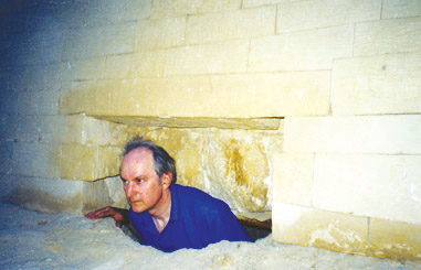 Professor Robert Temple inside a cavities located in the rear part of the Great Sphinx. © Copyright New Dawn Magazine, http://www.newdawnmagazine.com